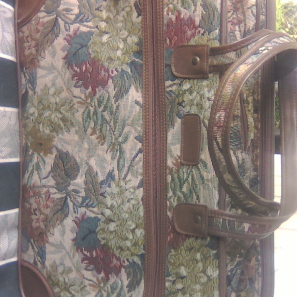 Suitcase with triple compartments & floral brocade pattern. Perfect travel size.